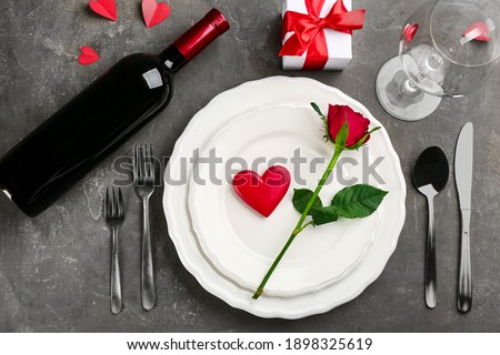 Beautiful table setting for Valentine's Day dinner on grey background, flat lay