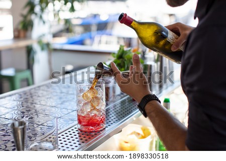 Expert Barman is Making Cocktail at Beach Bar Royalty-Free Stock Photo #1898330518