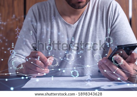A client is signing the contract to create a software to present it at start up conference and gain investments for innovative service. Checking the details at smartphone. Hologram tech graphs.