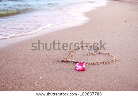a heart in the sand on the seashore