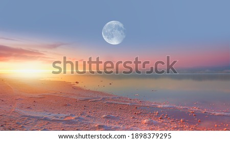 Maharlu pink salt lake with Full moon at sunset - Shiraz, Iran "Elements of this image furnished by NASA"