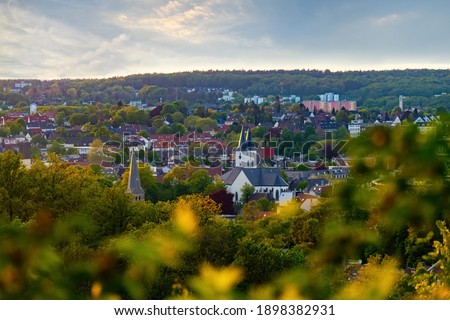 Panorama of Iserlohn Sauerland with warm evening light atmosphere on a late spring day with churches, old town, houses and inner city in wide low mountain scenery of North rhine westphalia Germany. Royalty-Free Stock Photo #1898382931