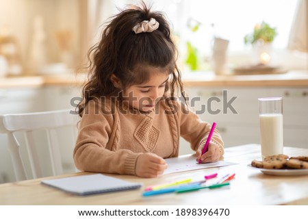 Indoor Portrait Of Small Adorable Girl Drawing Picture At Table In Kitchen, Cute Female Child Doing Homework, Enjoying Domestic Leisure And Kids Development Activities, Free Space