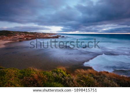The idyllic Pearses Beach and headland around Pirates Bay Cove on a hot summer's evening near Blairgowrie, Victoria, Australia