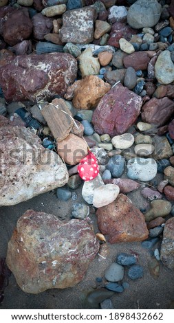 Heart printed deflated balloon in a stones ground 