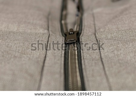 Metal zipper on the sports jacket. Close up. Selective focus