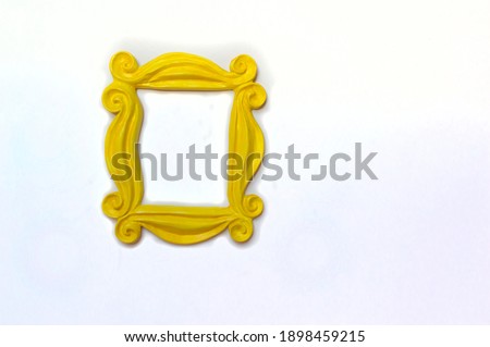 Yellow photo frame or mirror frame with a white background, to frame texts or images.