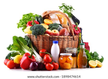 Wicker basket with assorted grocery products including fresh vegetables and fruits Royalty-Free Stock Photo #1898474614
