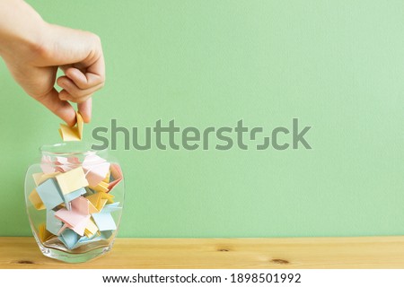 Draw lots. Folded colorful papers in bowl Royalty-Free Stock Photo #1898501992