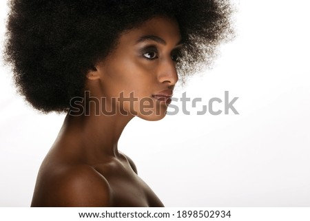 Portrait of pretty afro american woman in a studio for a beauty session - Beautiful girl posing on colored background