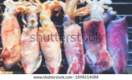 Blur picture, grilled Squid for background or wallpaper Cody space off food concept