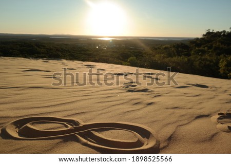 infinity sign painted in the sand on the beach in the desert of vietnam sand dunes of mui ne