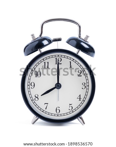 Closeup retro black alarm clock isolated on white background with clipping path, top view