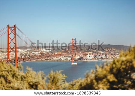 Lisbon, Portugal - March 29, 2019: panorama of the famous 25th April suspension bridge on the tage river Royalty-Free Stock Photo #1898539345