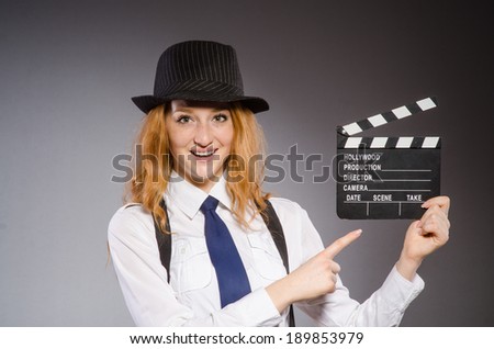 Young woman with movie board  