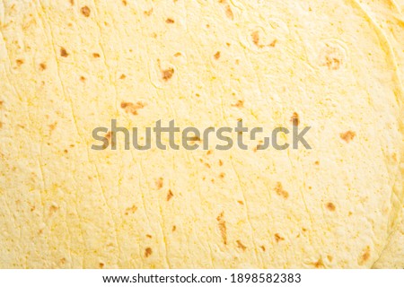 Homemade corn tortilla, on black background, top view flat lay with copy space for text