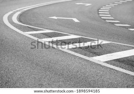 Close up asphalt road with curve and arrow to the left. intersection street. Explore transport concept. urban background. Empty street.