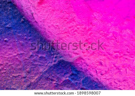 Beautiful bright colorful street art graffiti background. Abstract creative spray drawing fashion colors on the walls of the city. Urban Culture, orange , pink , purple , crimson, blue texture