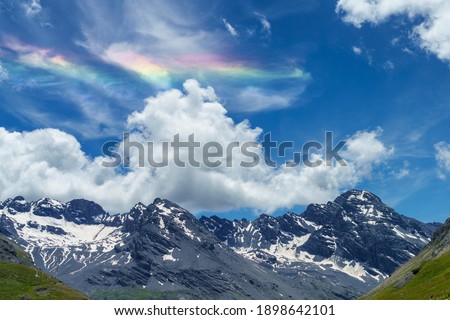 Iridescent cloud over the road to Stelvio pass, Sondrio province, Lombardy, Italy, at summer.