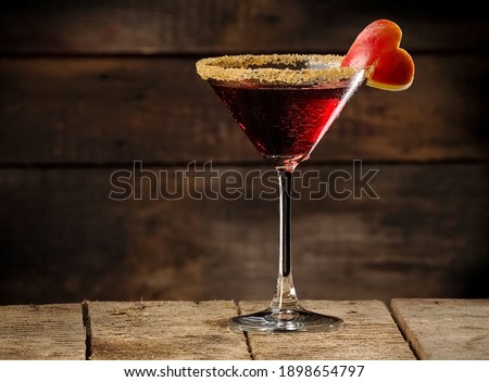 Red apple love martini cocktail on wooden background