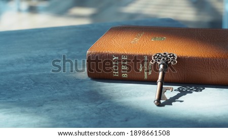 Key and bible on grey marble. Concept bible is key of life.  Key  Salvation is in bible.  Invaluable of God's word. Bible key success.  Christianity background.