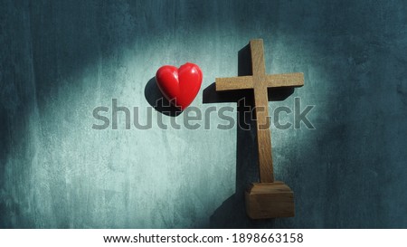 Red heart with wood crucifix on grey marble. Concept Jesus loves you, Jesus crucify himself on cross with love. Forgiving sin , God's love, Easter time , Faith God. Christianity background.