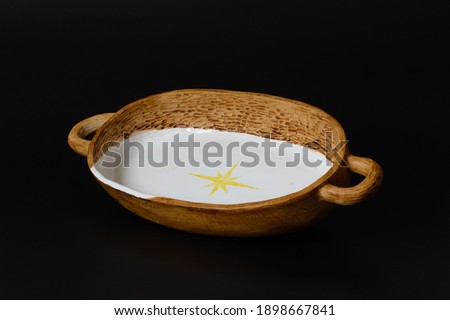 Photography of the authentic handmade ceramic craft ware on a black background. Bowl.