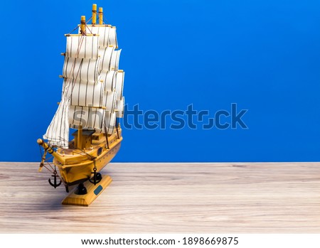 Souvenir boat on a blue background. Marine background.