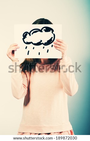 young woman holding picture with clouds rain