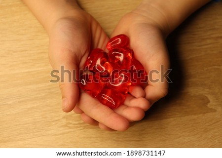 heart in hands close up, children's hands in hands, love and care, the concept of supporting mothers