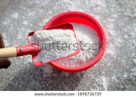 a shovel with sand for winter service