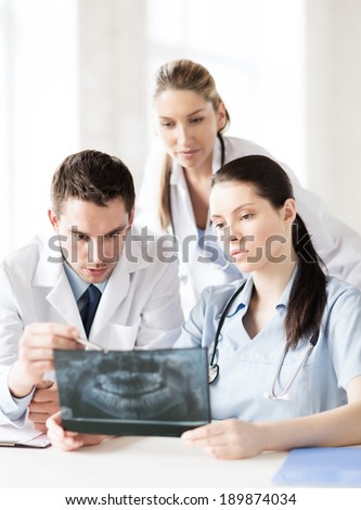 healthcare, medical and radiology concept - group of doctors looking at x-ray