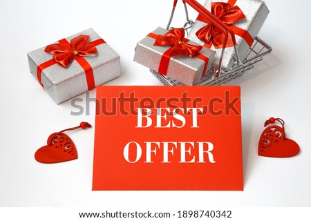Shopping cart with holiday purchases and text BEST OFFER on a red card, white background.