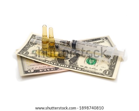 Medical laboratory vaccine against coronavirus. Two syringes with three vials of Covid-19 medicine on dollar bills. The concept of getting money for testing, affordable vaccination.