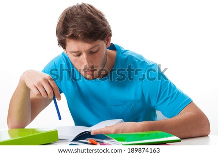 Male student working on task on isolated background