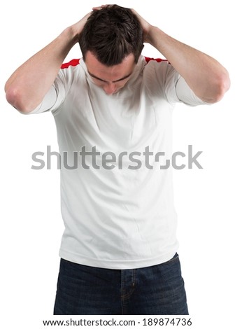 Disappointed football fan looking down on white background