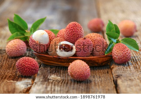 litchi, lichee, lychee, or lichi, Litchi chinensis on old rustic wood background  Royalty-Free Stock Photo #1898761978