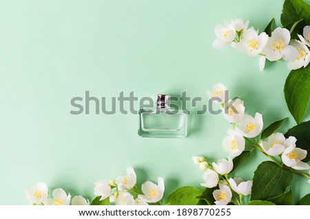 flowers and branches of jasmine perfume on green background. design spring floral greeting card, wedding invitation, natural cosmetic, packaging. copy space, text Royalty-Free Stock Photo #1898770255