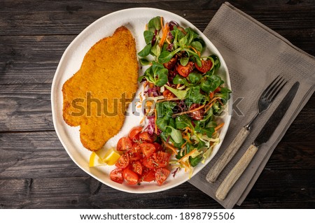 Top view of a chicken cutlet with vegetables Royalty-Free Stock Photo #1898795506