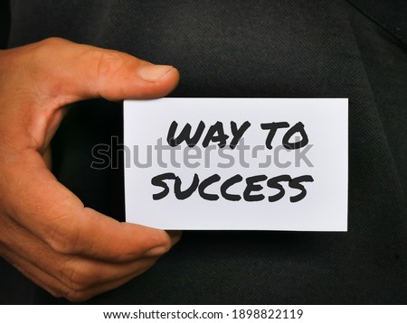 Selective focus image with noise effect hand holding white card with text WAY TO SUCCESS.Business concept.