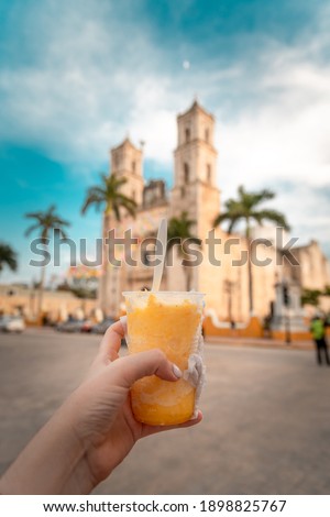 Young man drinking ice cream through the streets of Valladolid