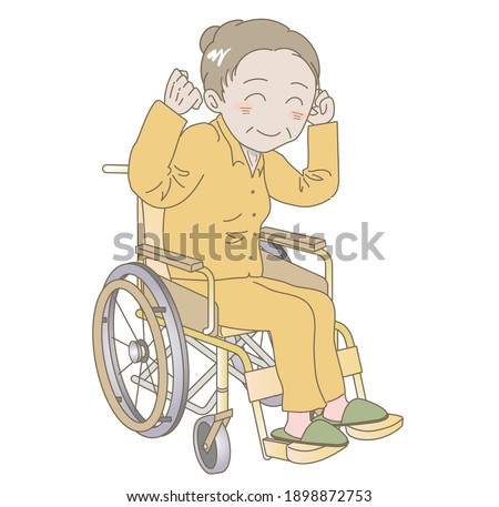Elderly woman sitting in a wheelchair with fist pump