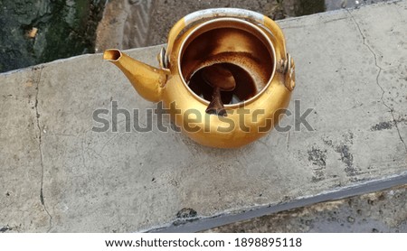 gold water kettle in front of the house