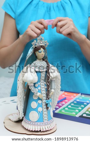 Plasticine modelling clay. Figure of russian woman. Developing activities, creative idea, hobby. Plasticine sculpture. Sculpts from plasticine modelling clay. Tsarevna Swan, plasticine Princess Swan