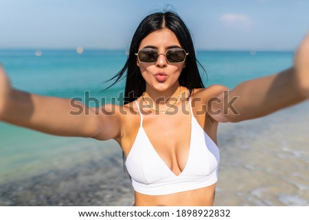 Young attractive woman making selfie at the beach