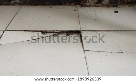 floor broken due to uneven foundation Royalty-Free Stock Photo #1898926339