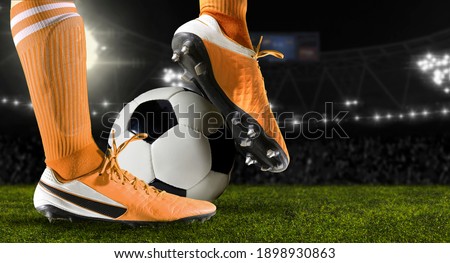 Football player man in action on dark arena background