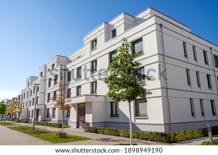 Street with modern white townhouses in Berlin, Germany Royalty-Free Stock Photo #1898949190