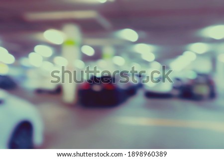 Abstract blurred car in parking lot of mall.