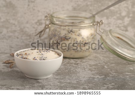 sugar with lavender in a jar is on the table	